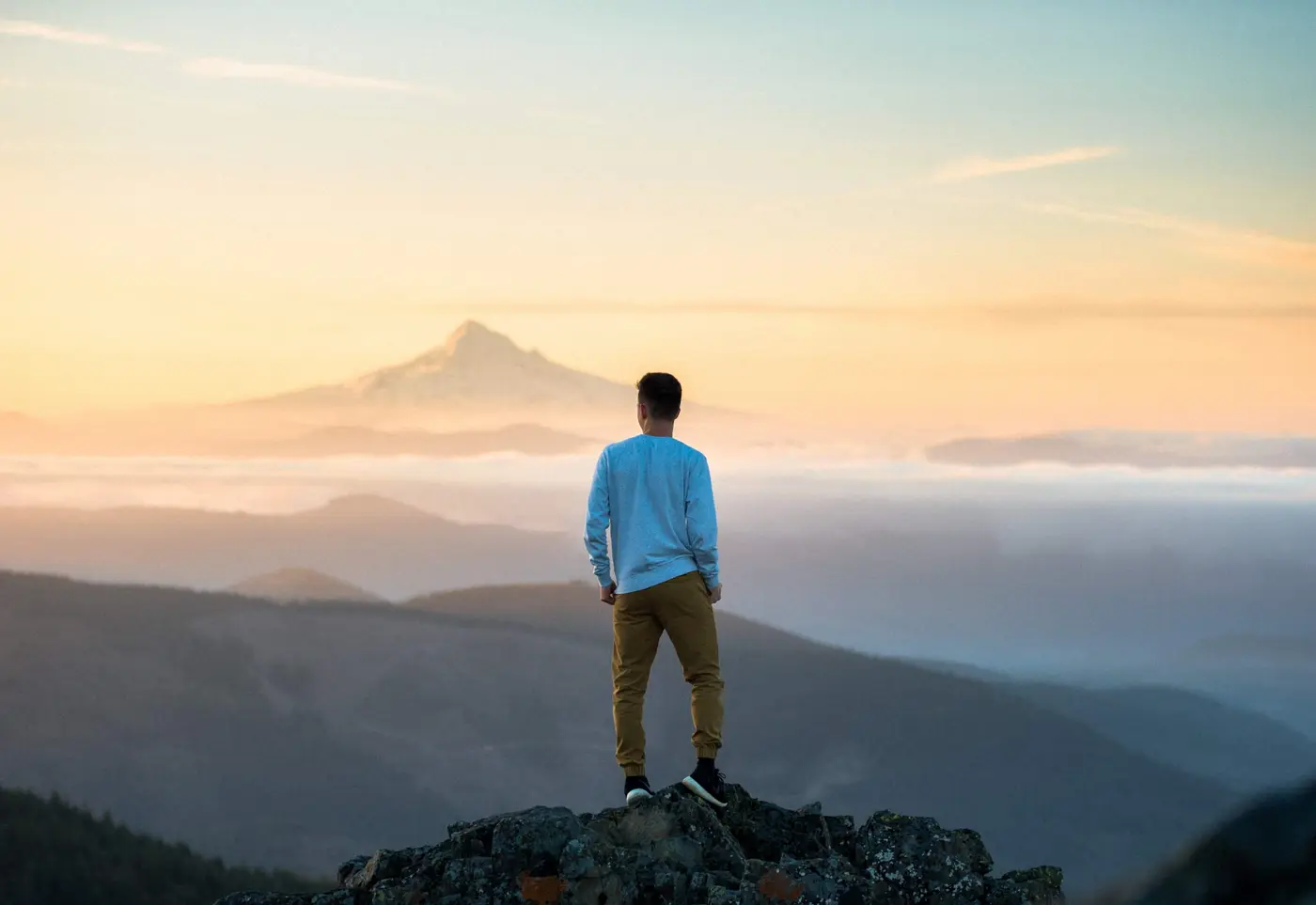 Searching for new horizons. Man on top of mountain