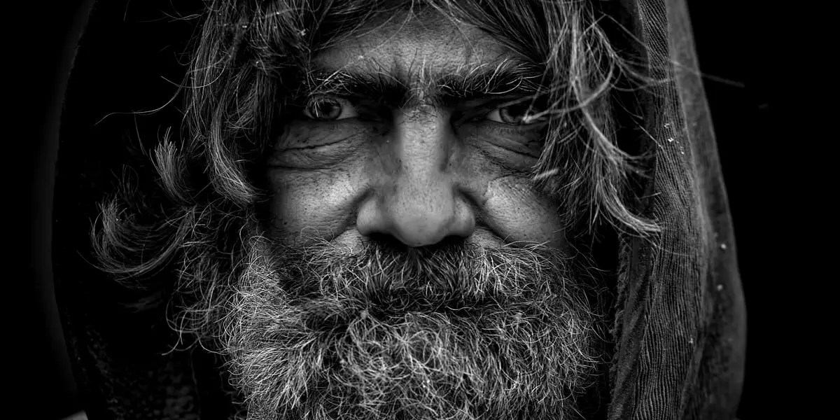 Homeless man wearing a hoodie with beard