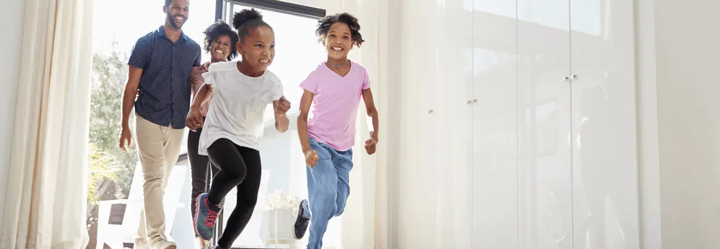 excited family running into new house